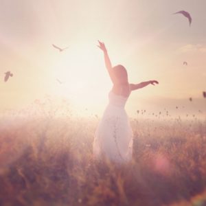 Girl with birds in field