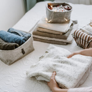 Woman reorganizing clothes unblock's her home's chi