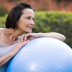 Woman content with exercise ball