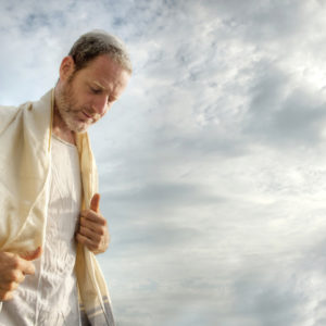 Jewish man engaged in morning prayers.