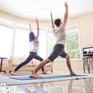 Man and woman practicing yoga at home