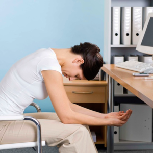 Woman at desk in yoga pose