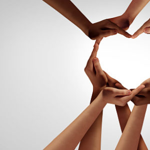 Unity and diversity partnership as heart hands in a group of diverse people connected together