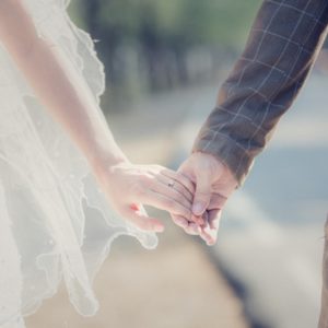 Bride and groom holding hands