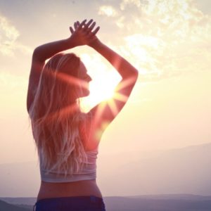 Woman stretching in morning with sun