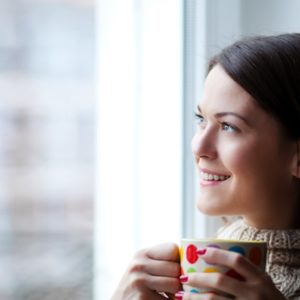 Woman smiling with coffee