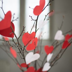 Heart-centered spirituality represented by branches with paper hearts.