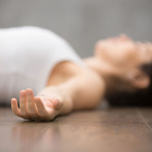 Woman relaxing in savasana