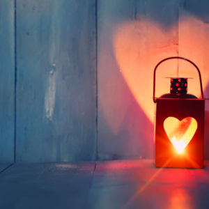 Lantern glowing red with a heart shaped cut out