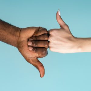 masculine and feminine hands giving thumbs up and thumbs down for saying no