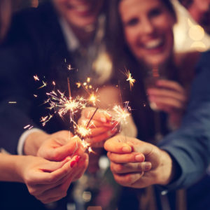 Happy people celebrating with sparklers