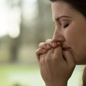 Woman crying outdoors for no reason, empath