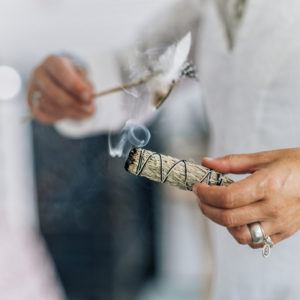 People burning sage to cleanse energy