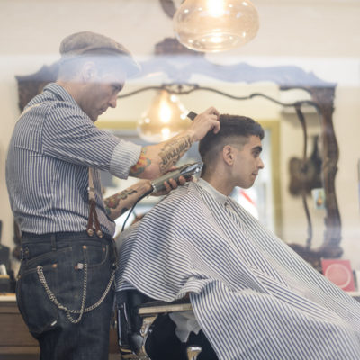 man getting haircut at barber shop