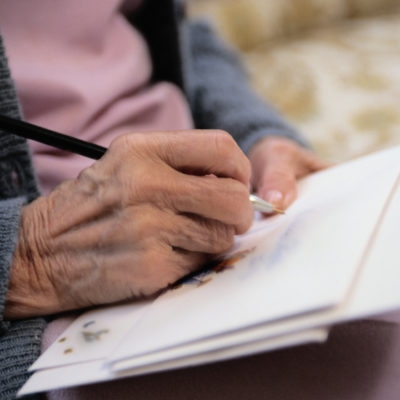 Woman writing a letter by hand