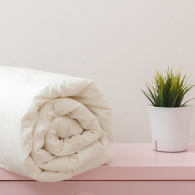 feather duvet, rolled up on table