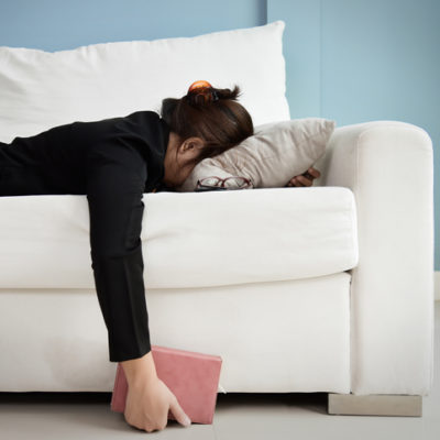 Exhausted woman on couch