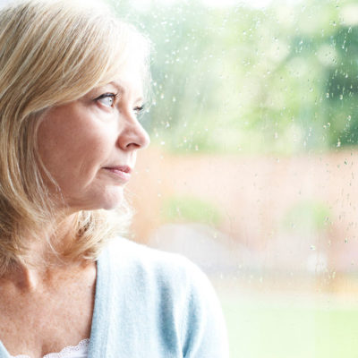 Senior woman looking out window