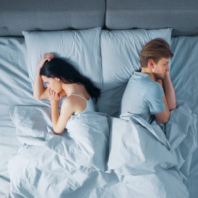 People facing away from each other in bed have reasons for saying no to sex