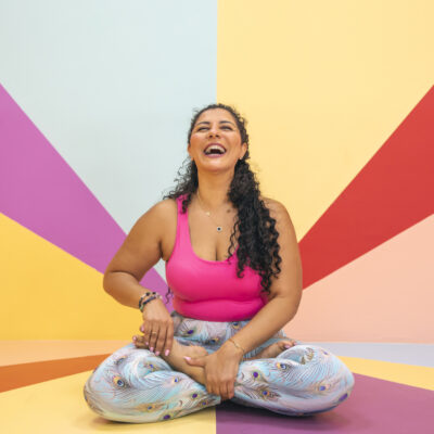A beaming woman doing yoga shows how to raise your spiritual vibration