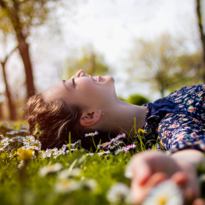 Happy woman lying on grass