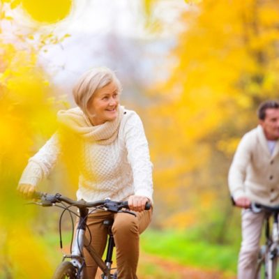 Couple riding bikes in fall