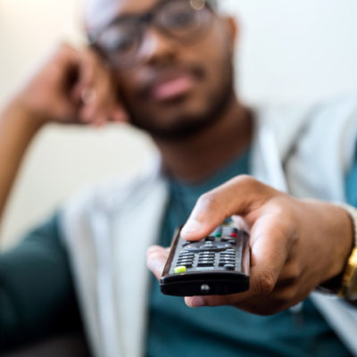 A man holds a remote control.