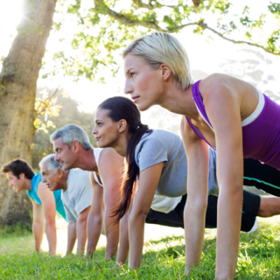 People exercising in plank pose in the park