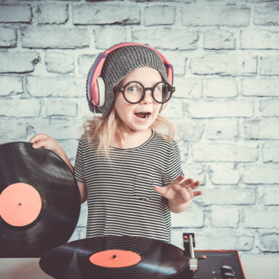 Little girl with pink records playing DJ.