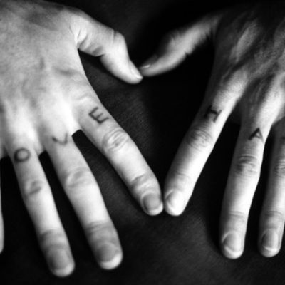 Love Hate tattooed on hands