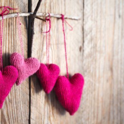 Crocheted hearts on wood wall