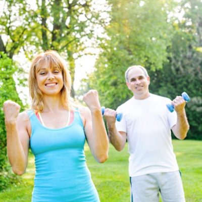 Two older people exercising outdoors