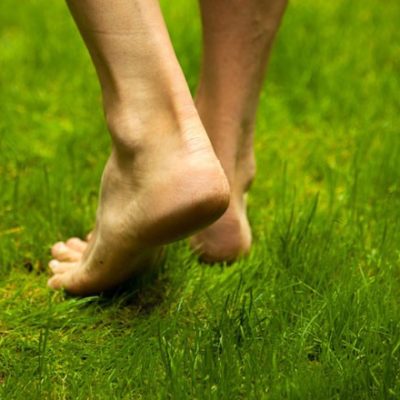 Man walking barefoot on grass