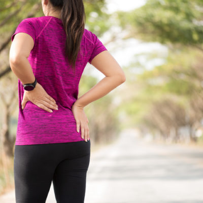 a woman stretches her back