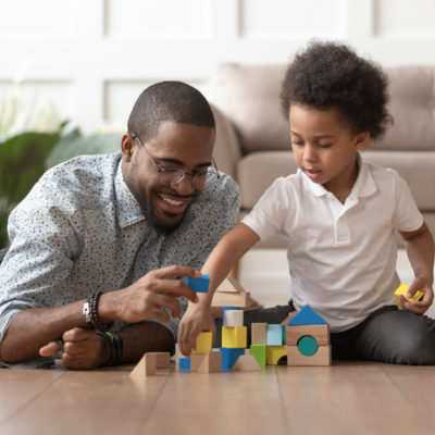 Happy dad and son building with blocks