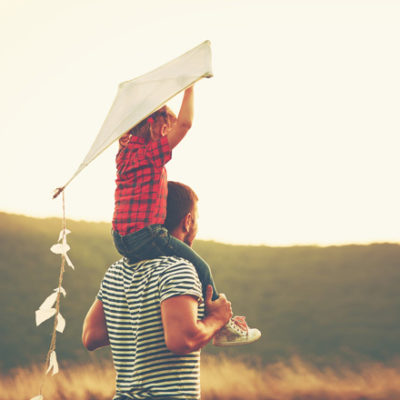 father and kid with kite