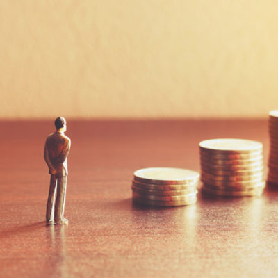 man and stacks of coins