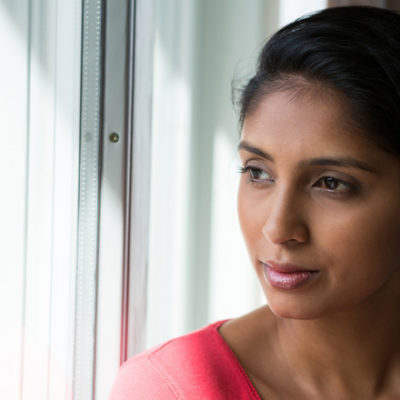 woman looking out window