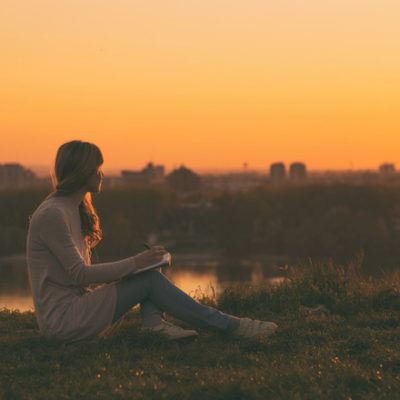 women writing at sunset