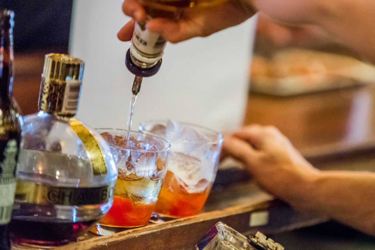 Pouring a spirit into a cocktail glass