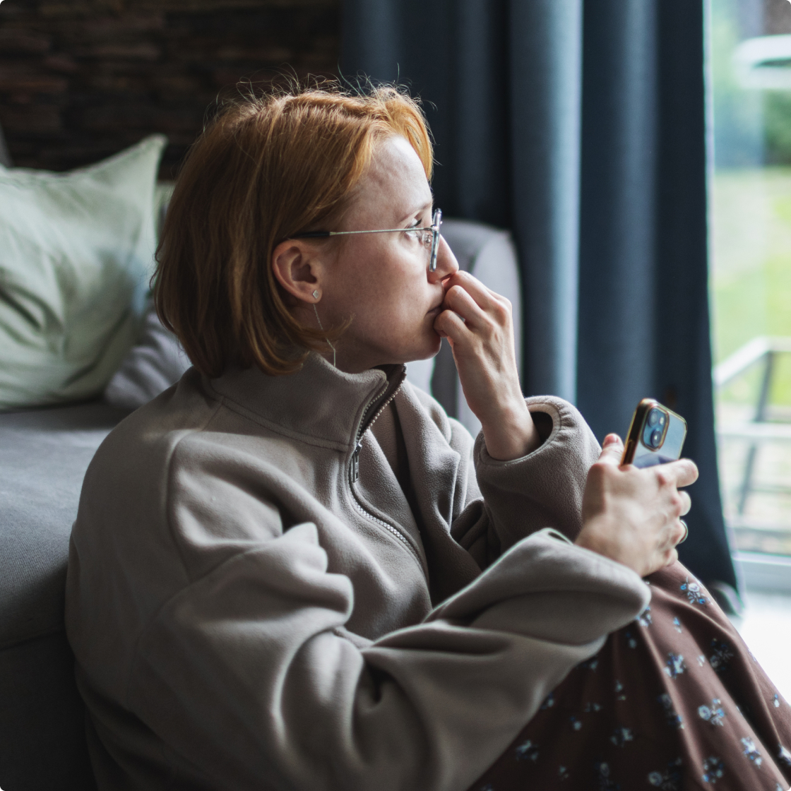 deeply saddened women with a phone
