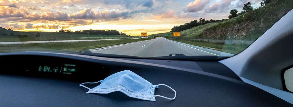 Medical Protective face mask in the car, driving on a road