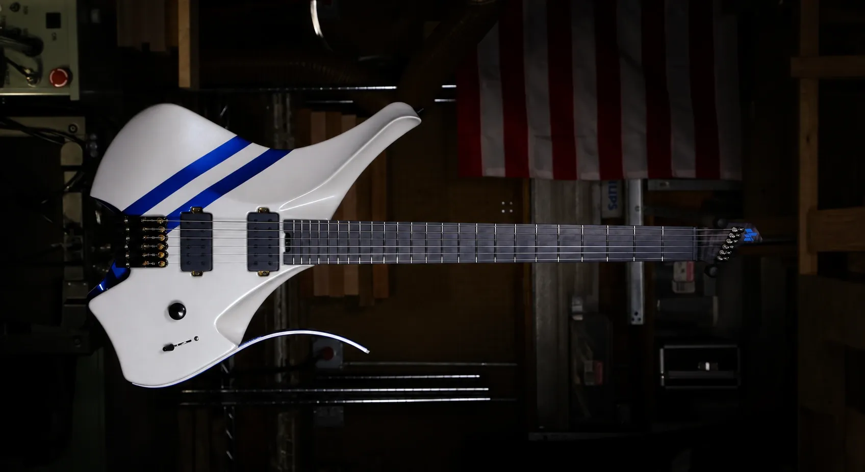 White Headless Virtus guitar with blue racing stripes