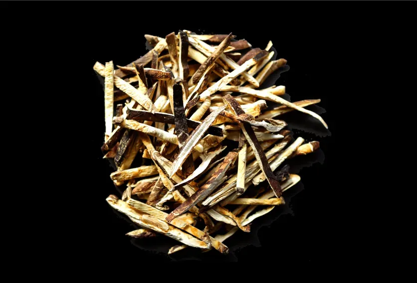 A pile of cut dried shiitake strips in a bulk business-use format, on black.