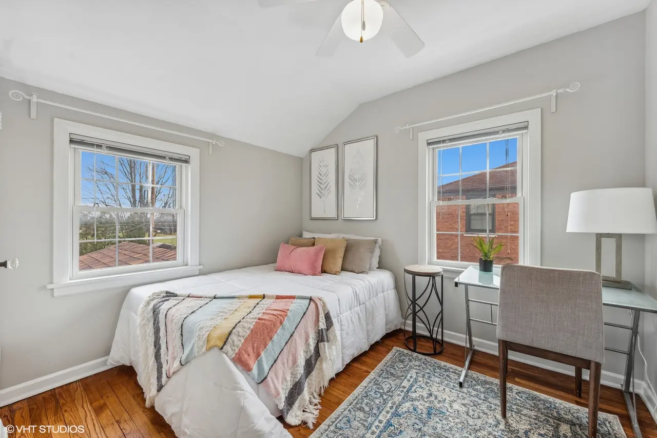 La Grange Illinois non-primary bedroom transformation showcasing the effect of professional staging with tasteful furnishings and decor to highlight the room's potential.