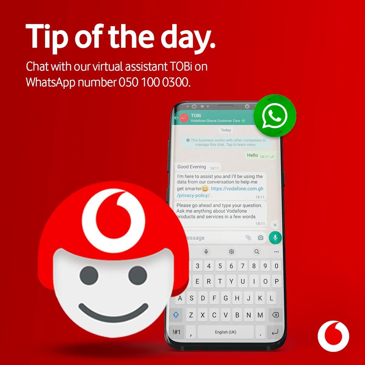Vodafone Ghana ad promoting its TOBi virtual assistant on WhatsApp, showing a phone chat where TOBi invites the customer to type their question in a few words.