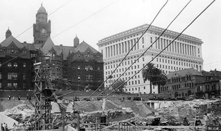 Hall of Justice in 1927, with work proceeding in a nearby quarry that would soon be the Los Angeles City Hall. Behind and to the left stands the old County.