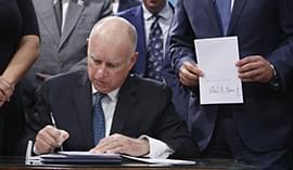 Former Governor Jerry Brown signing a Senate bill into law. Courtesy of the Washington Times.