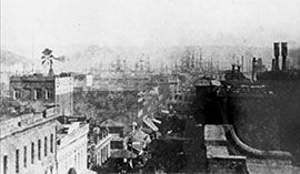 The first courthouse in San Francisco at 640 Clay Street in 1874. The courthouse would serve as the center for justice in San Francisco until 1881. In the back are masts of ships anchored in the bay.