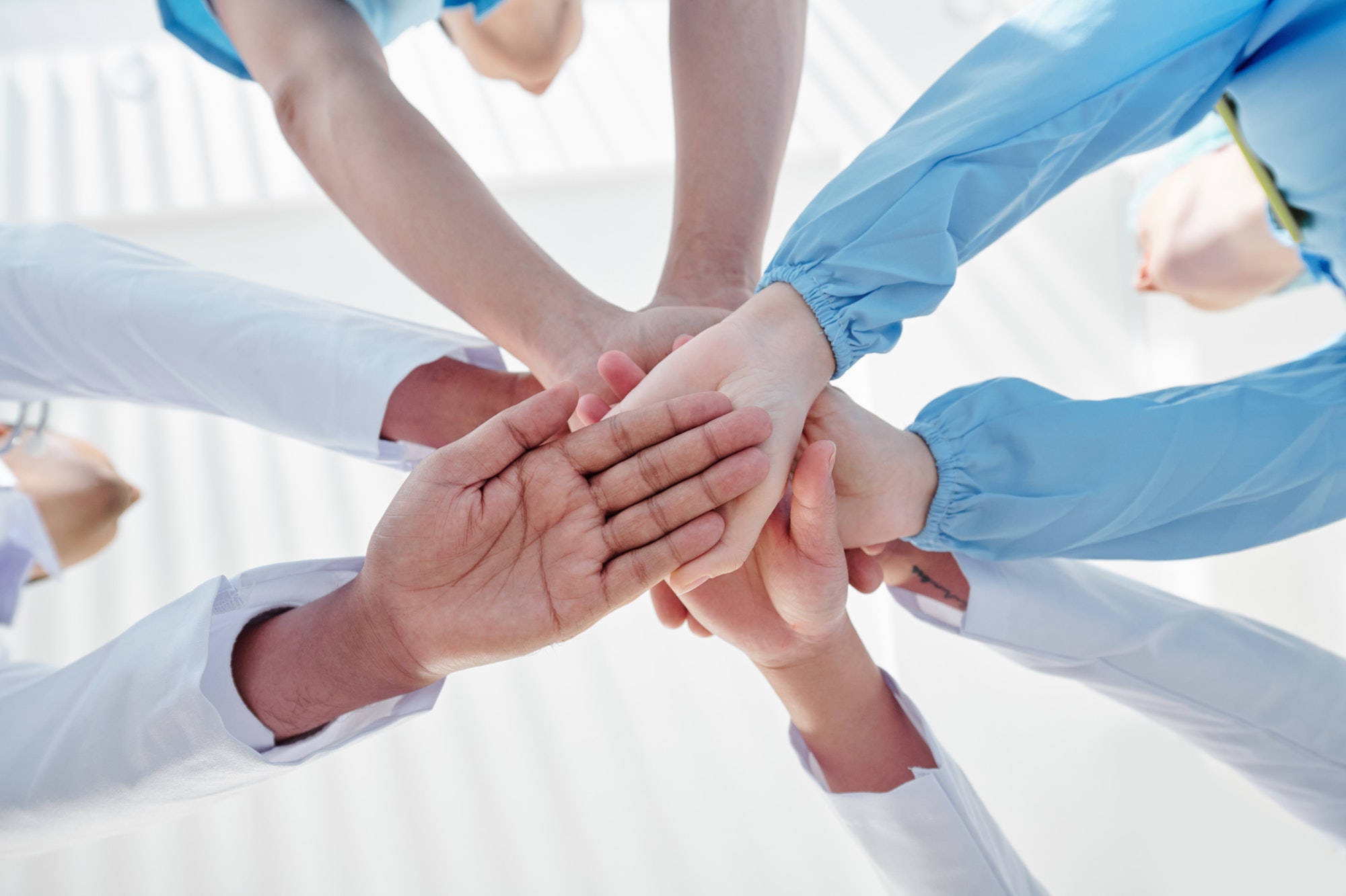 Medical workers stacking hands